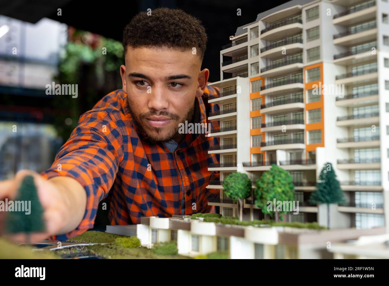 Biracial male architect working on a building model at office Stock Photo