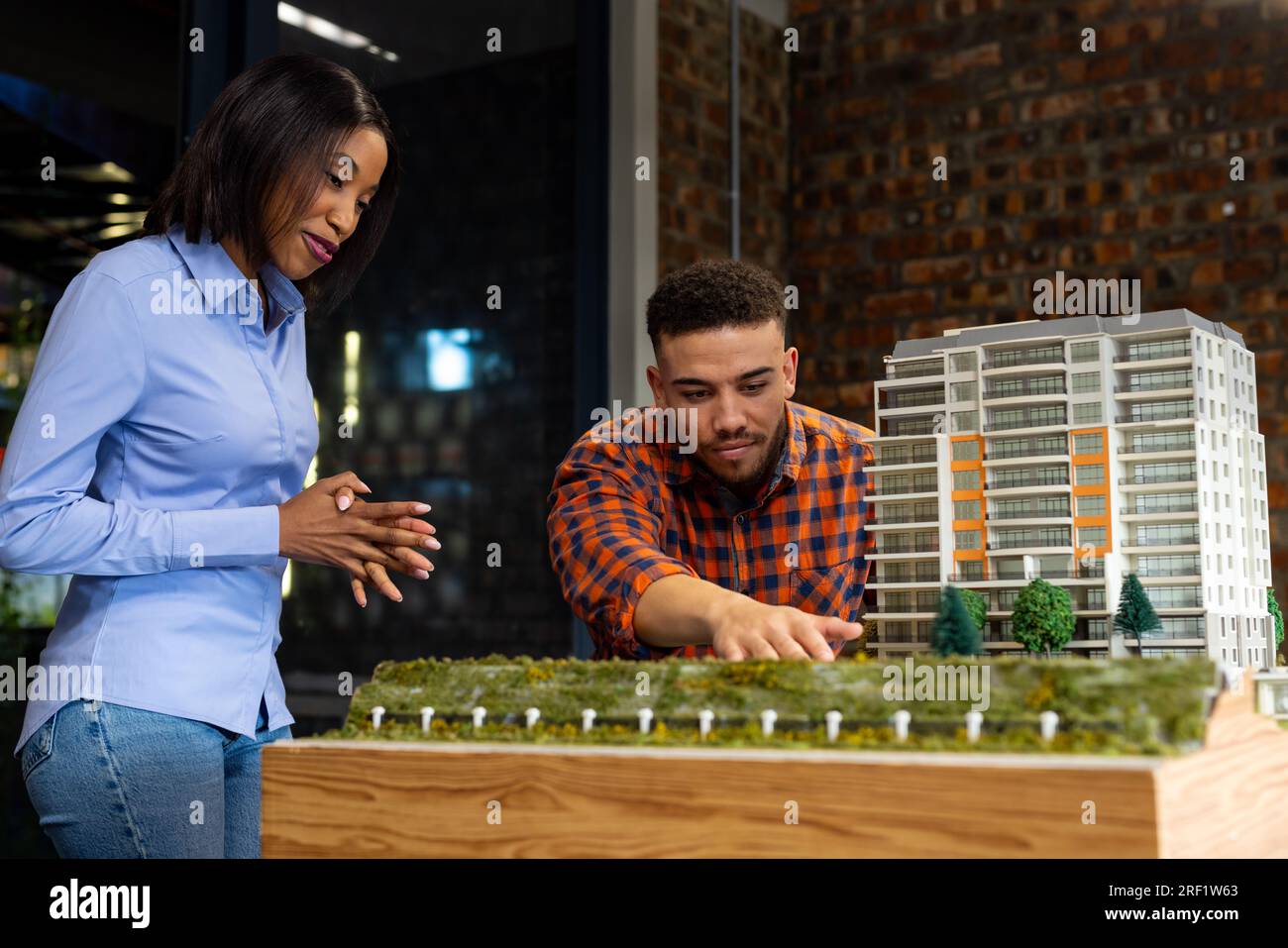 Diverse male and female architects discussing and working on a building model at office Stock Photo
