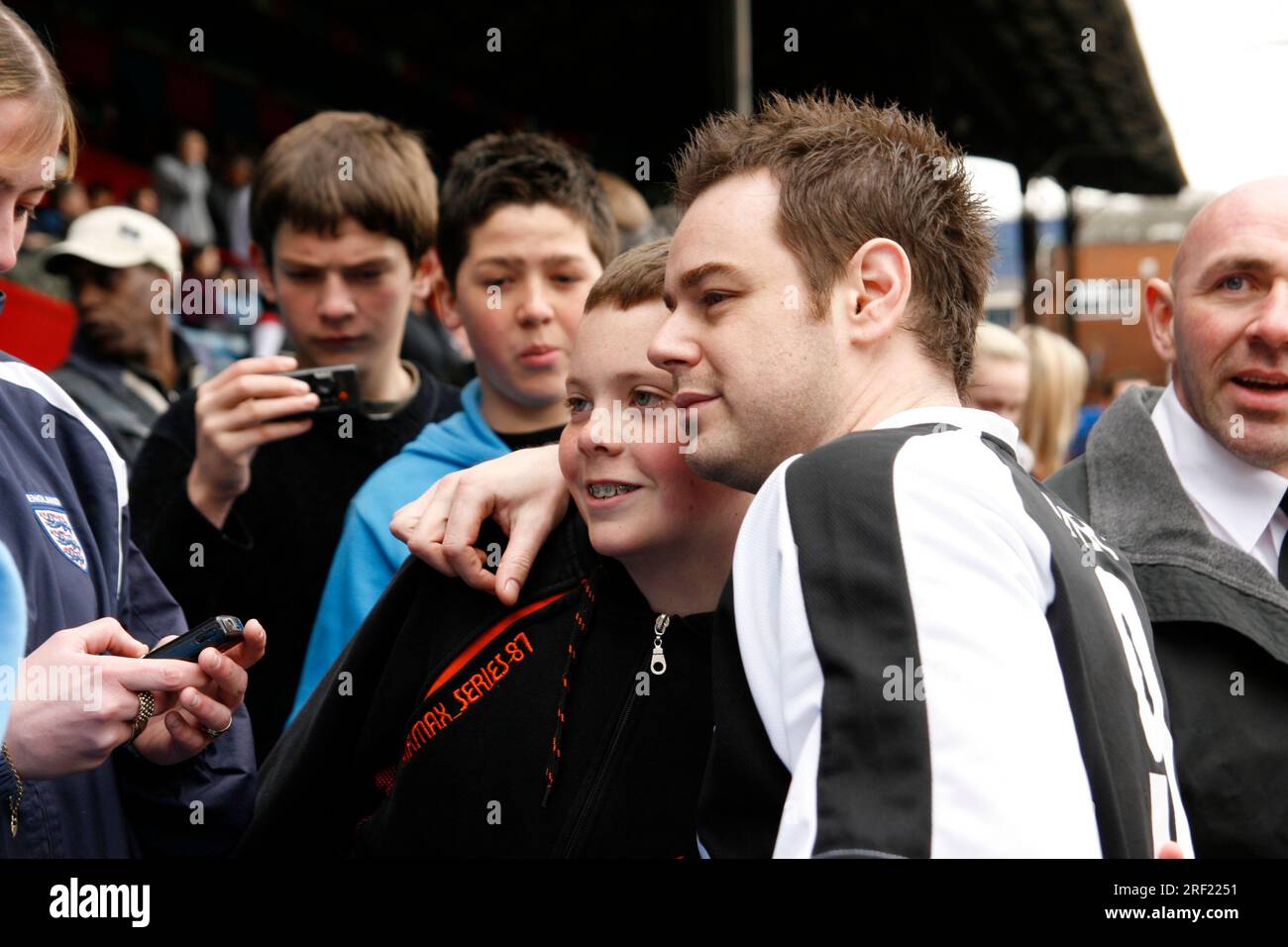British actor Danny Dyer posing for photographs with fans at a charity match at Selhurst Park
