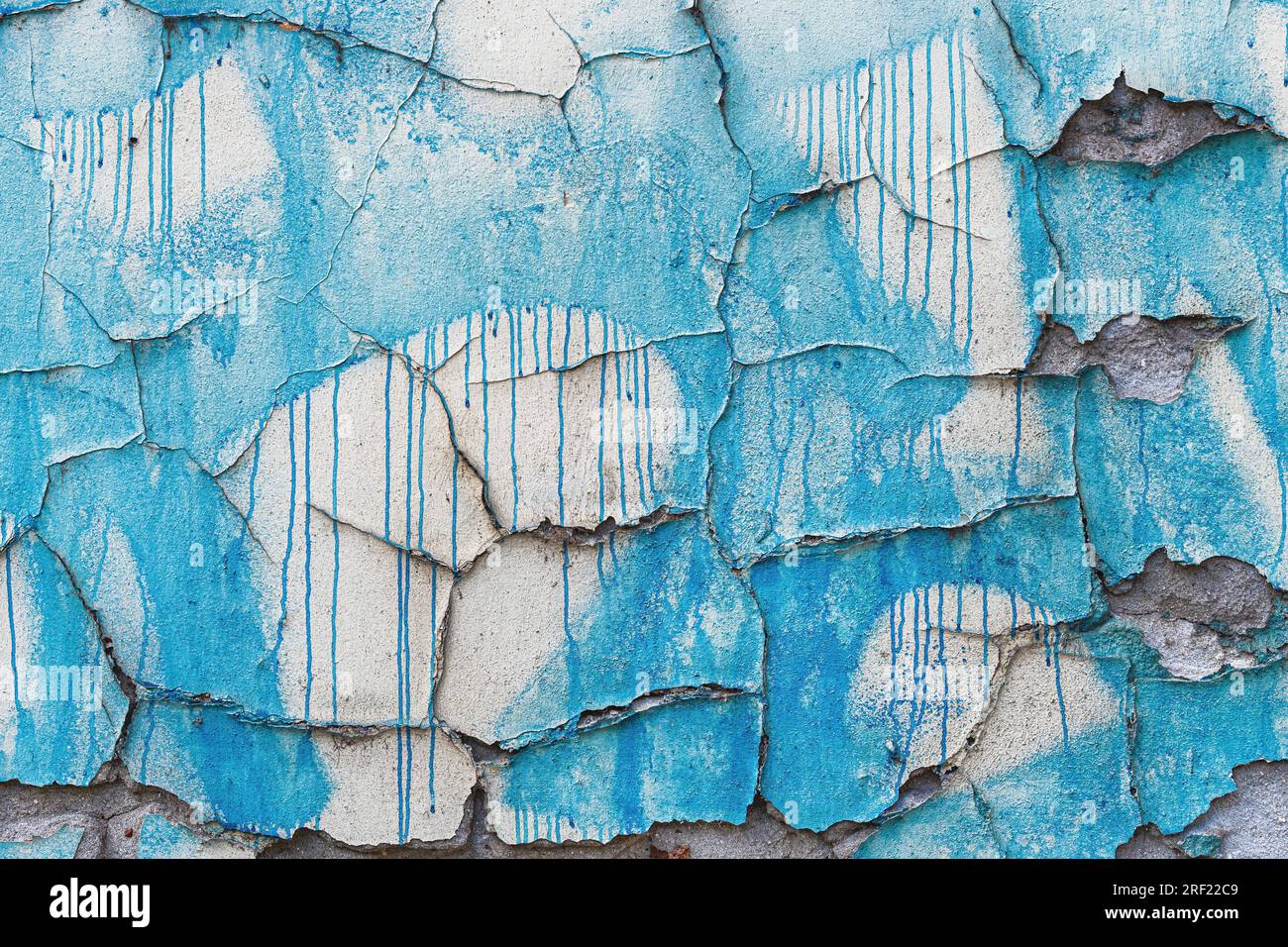 Paint spill over the old damaged cracked concrete wall as grunge background Stock Photo