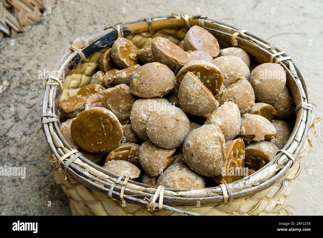 A basket full of Chillu Karuppatti unrefined brown sugar made from palm