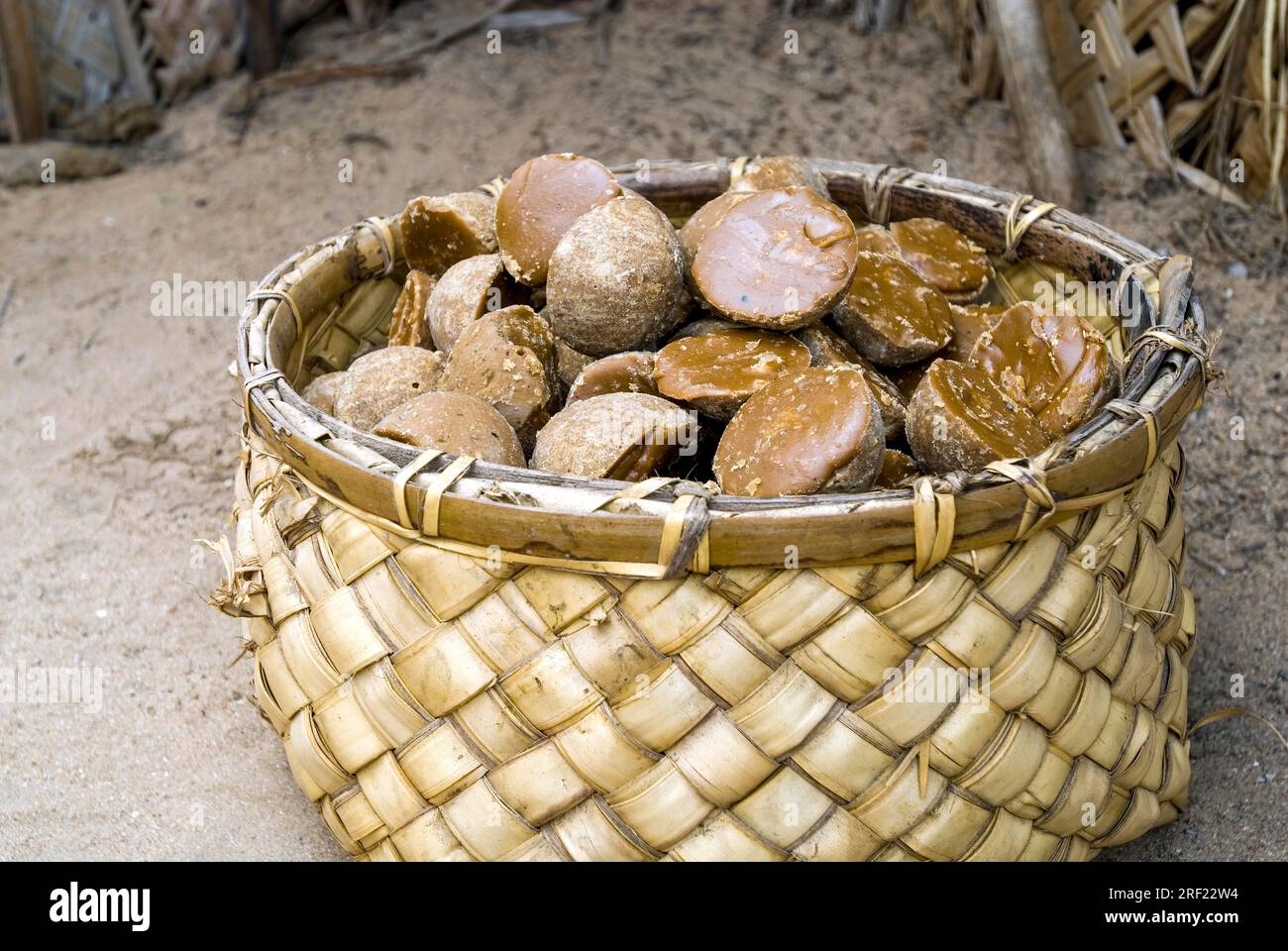 A basket full of Chillu Karuppatti unrefined brown sugar made from palm