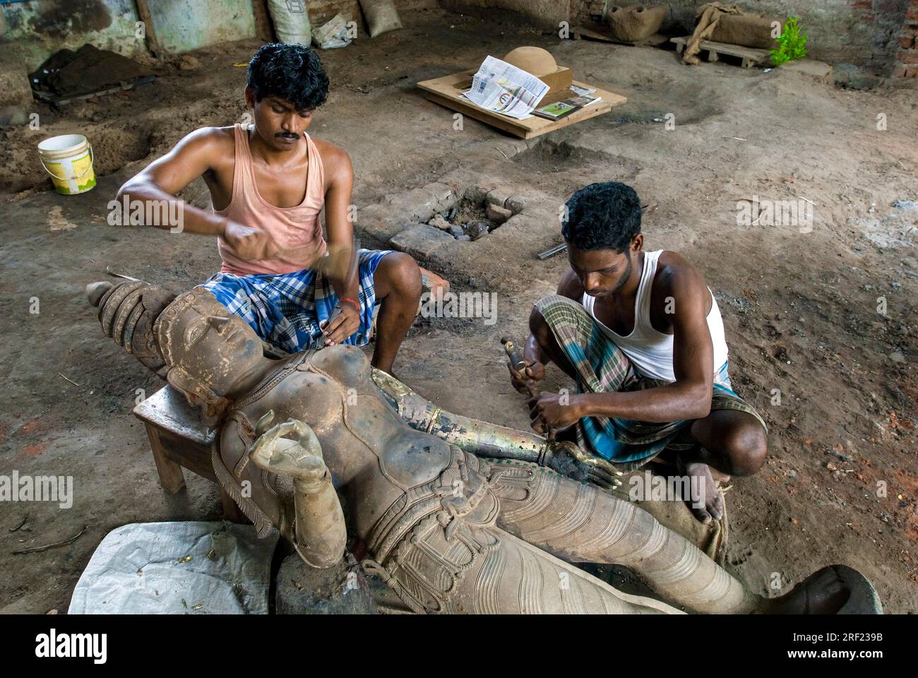 Artisans chiselling bronze sculpture statue at Swamimalai, Tamil Nadu