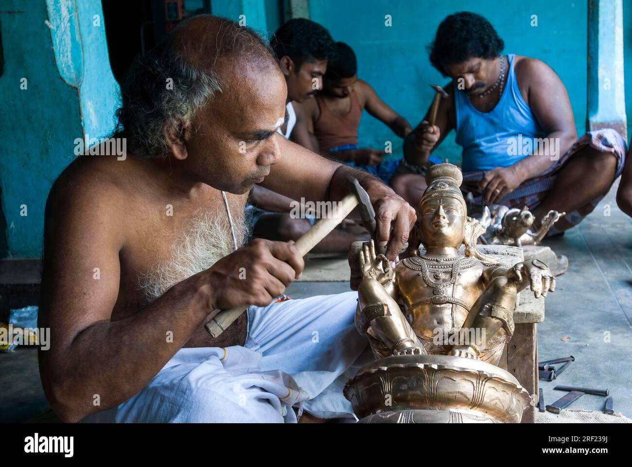 Artisans making carving bronze sculpture statue at Swamimalai, Tamil Nadu, South India, India