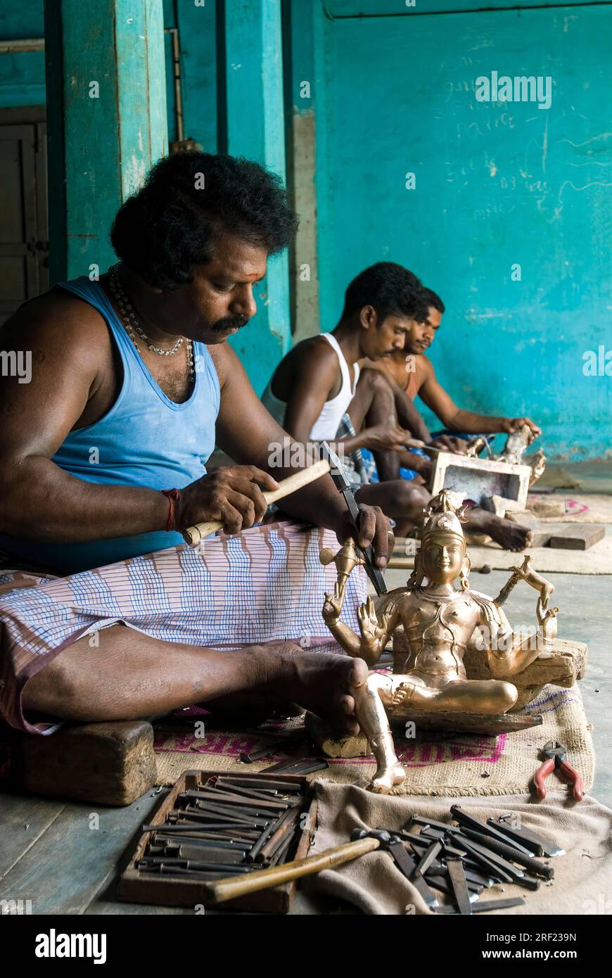 Artisans making carving bronze sculpture statue at Swamimalai, Tamil