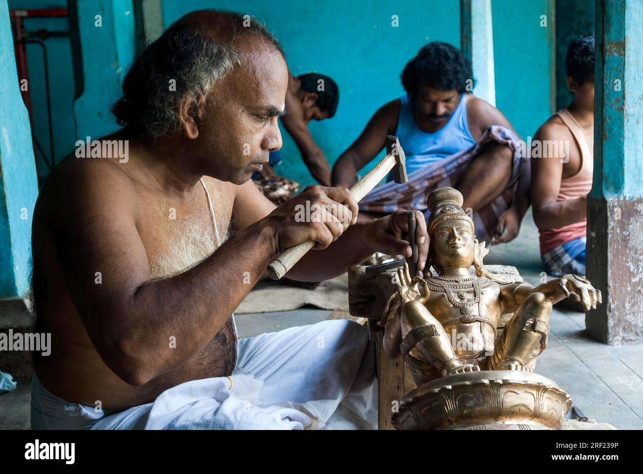 Artisans making carving bronze sculpture statue at Swamimalai, Tamil