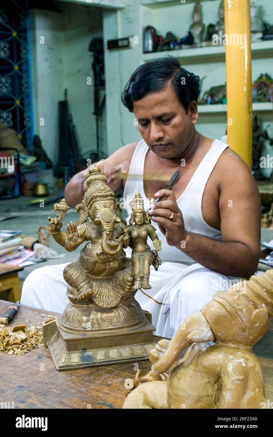 An artisan Chiselling bronze sculpture statue at Swamimalai, Tamil Nadu