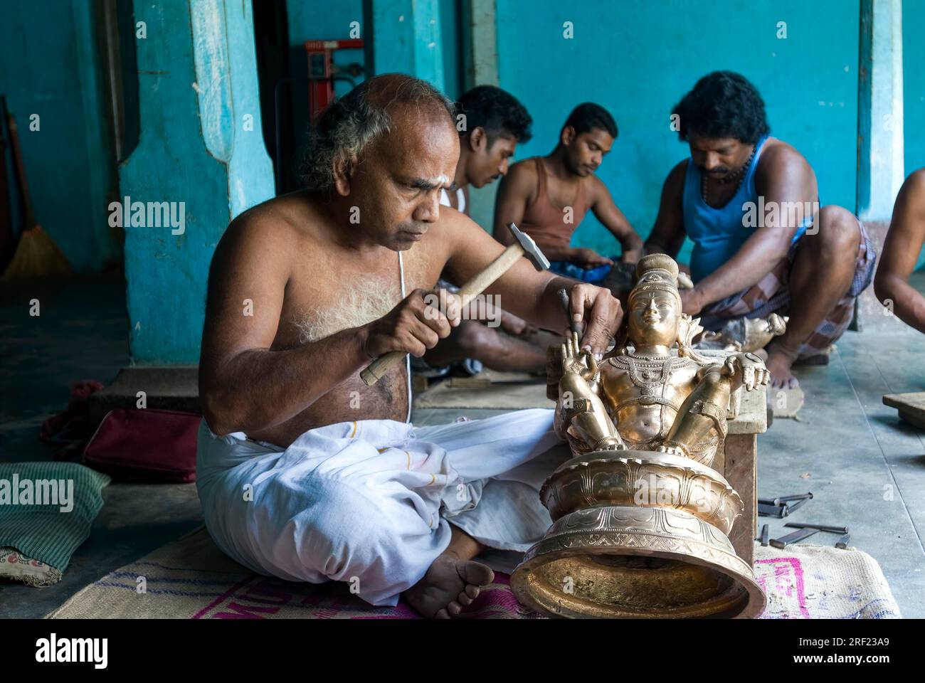 Artisans making carving bronze sculpture statue at Swamimalai, Tamil