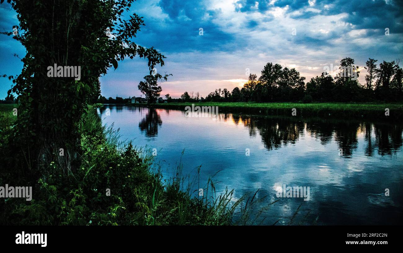 Cloudy sky before storm on river ,Italy Stock Photo