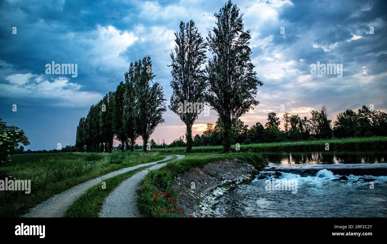 Cloudy sky before storm on river ,Italy Stock Photo
