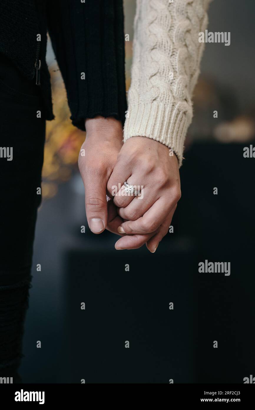 Couple holding hands and showing engagement ring Stock Photo