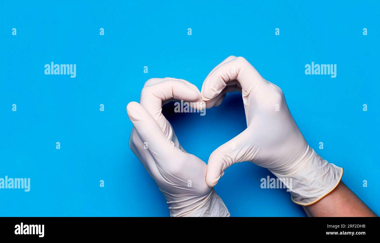 https://c8.alamy.com/comp/2RF2DHB/doctors-hands-in-medical-gloves-in-shape-of-heart-on-blue-background-with-copy-space-2RF2DHB.jpg