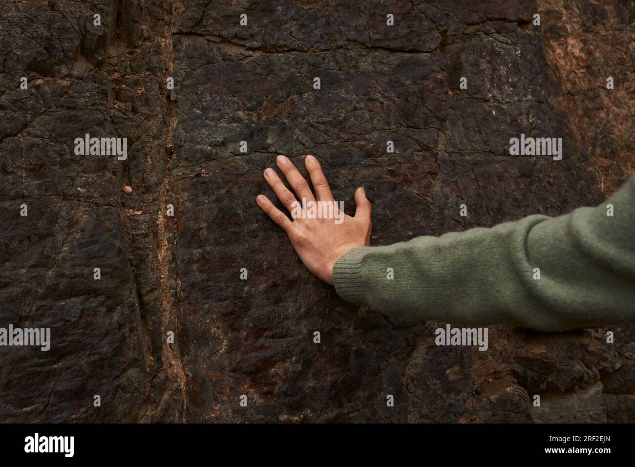man's hand touches the rock Stock Photo - Alamy