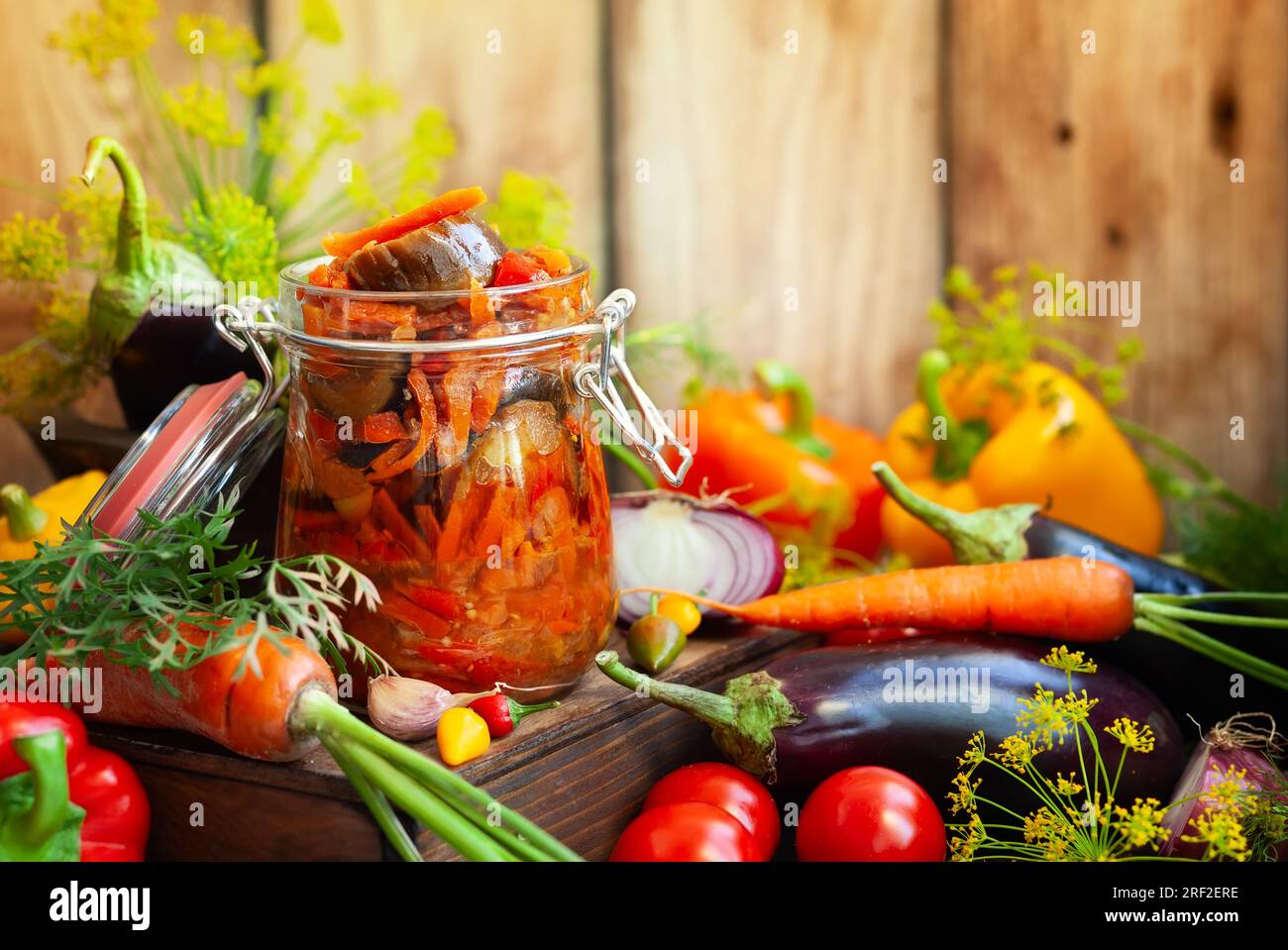 Homemade preserved from eggplant with vegetables in glass jar -ratatouille. Fall preserved vegetarian food concept, copy space. Stock Photo
