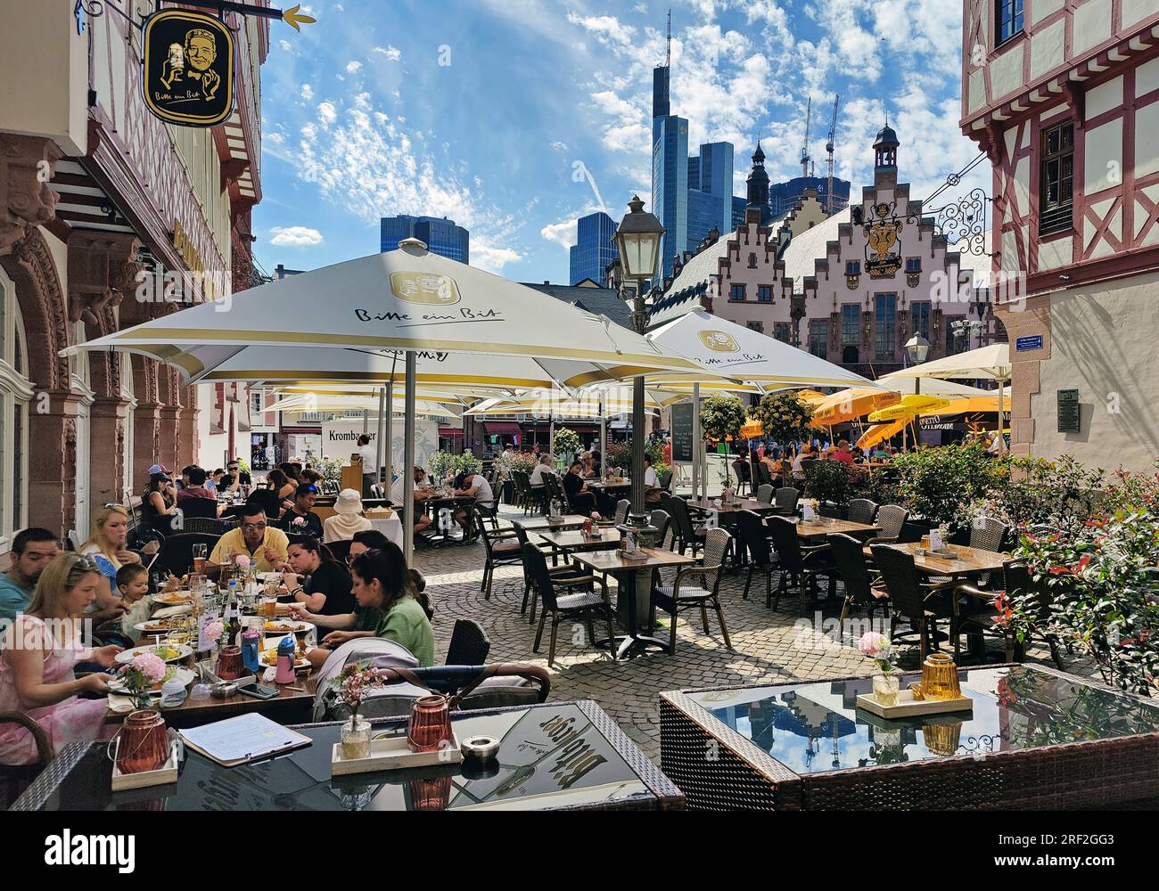 outdoor restaurants on the Roemerberg with the town hall and the Commerzbank, Germany, Hesse, Frankfurt am Main Stock Photo
