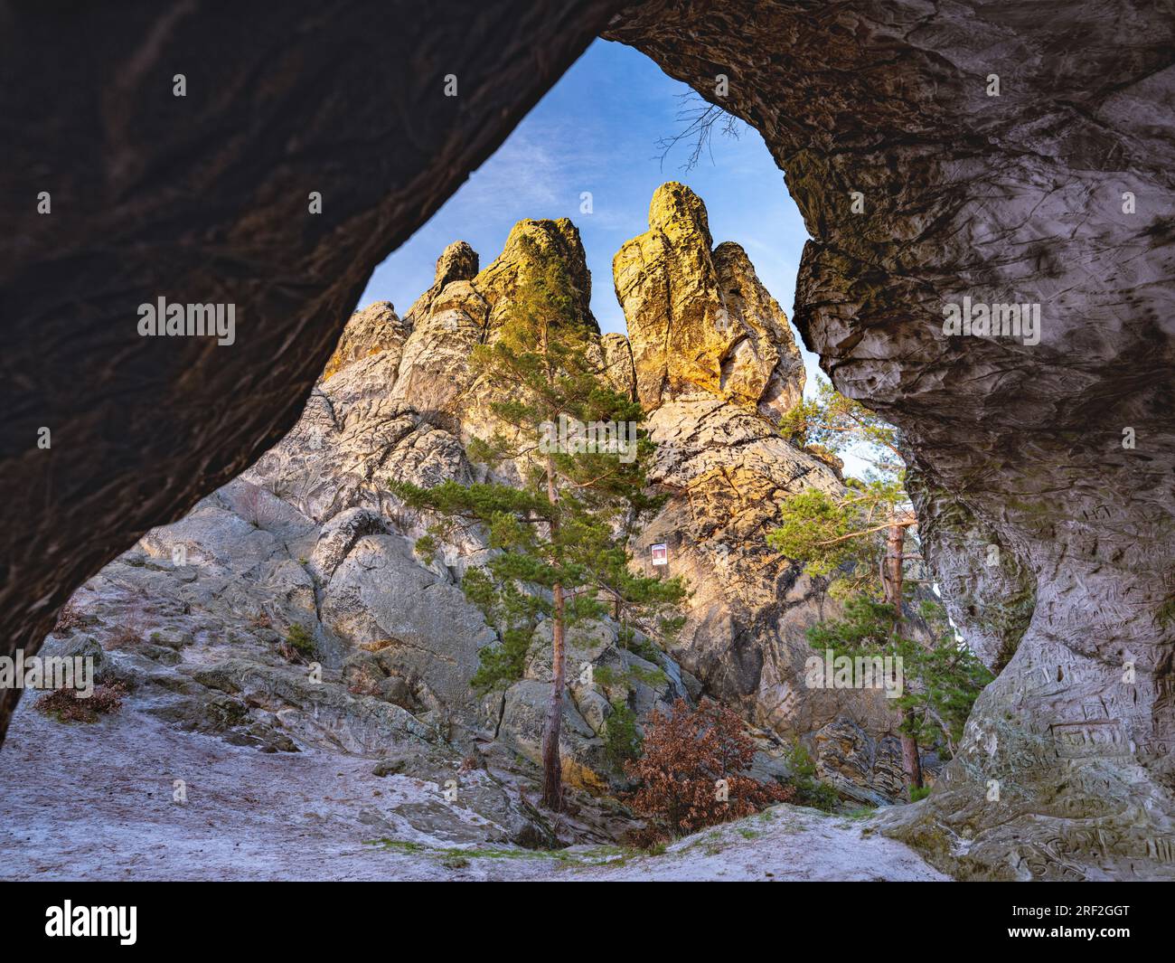 View from a cave toward dramatic natural rock formations in a protected nature reserve