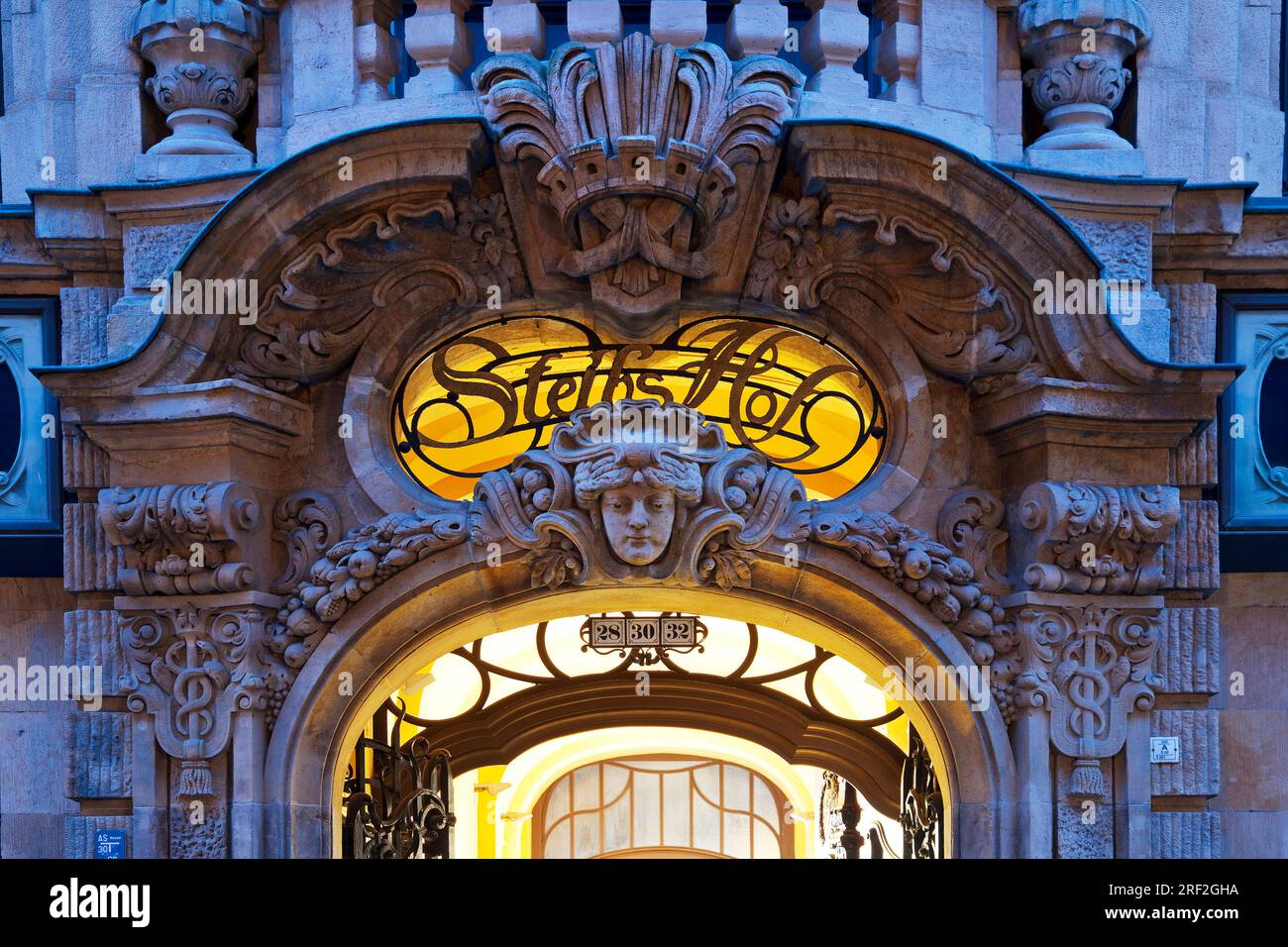 Neo-baroque architectural decoration on the portal of Steibs Hof at the blue hour, Germany, Saxony, Leipzig Stock Photo