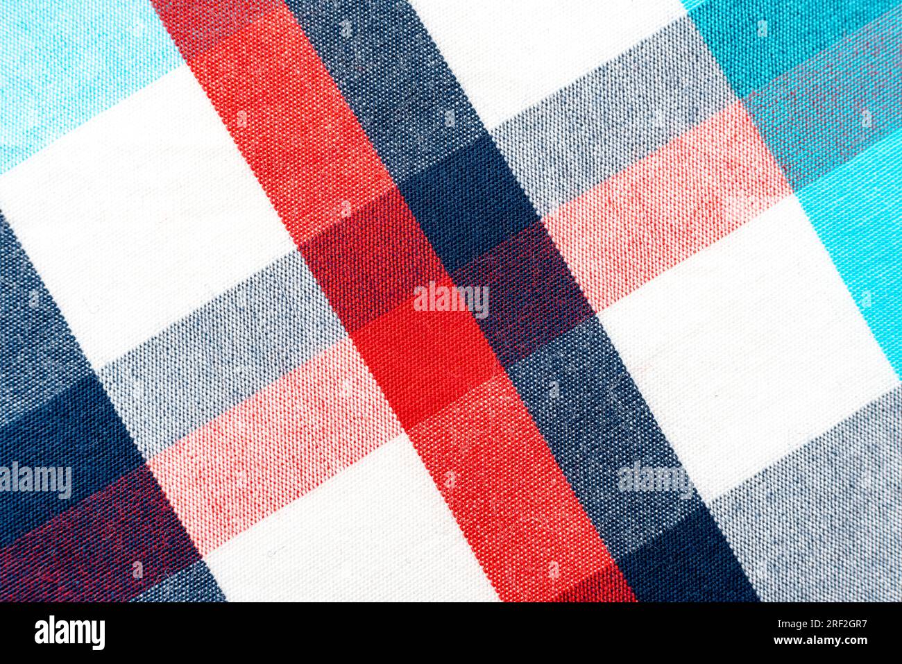 The texture of linen fabric in a large cell of red, blue and white. Scottish tailoring material. checkered fabric Stock Photo