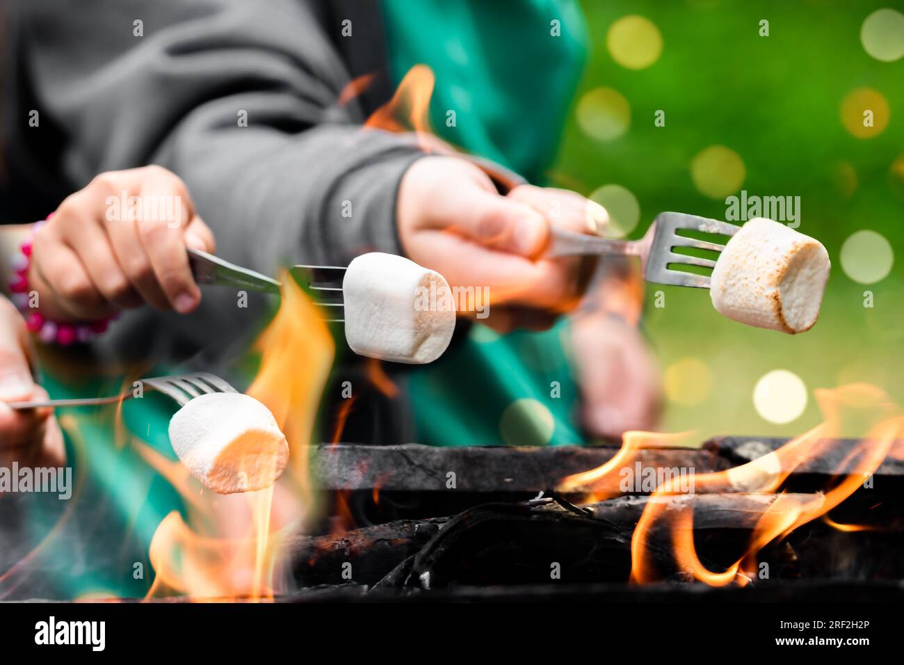 Around the campfire. Delicious and sweet jelly marshmallows on fork