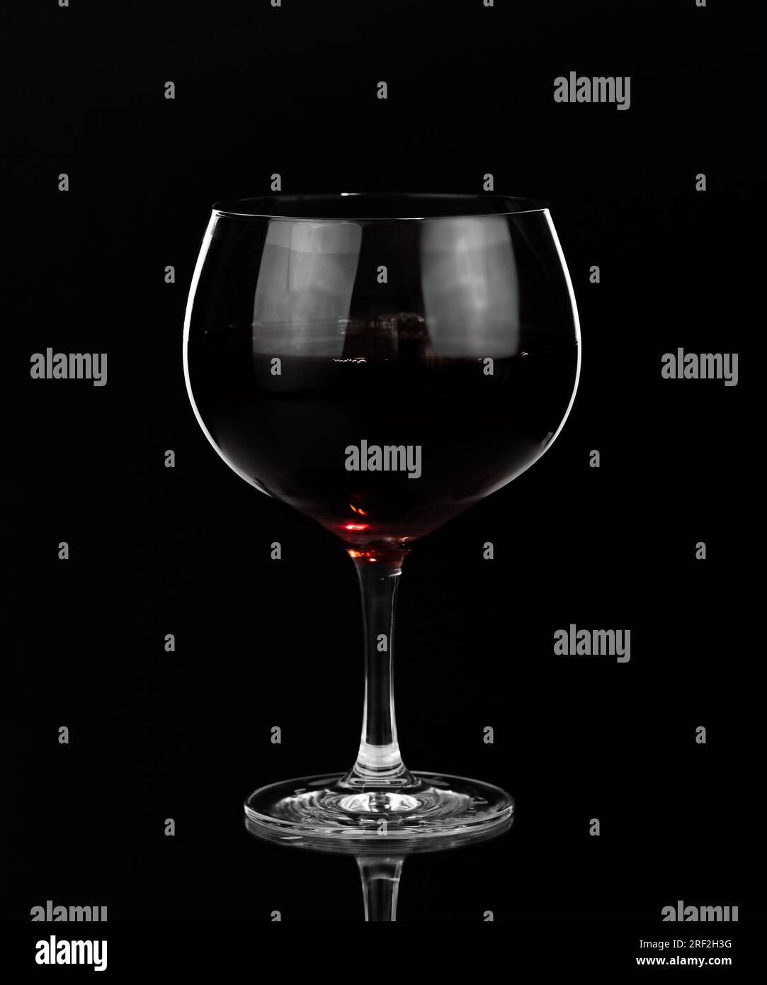 Glass of red wine on dark background. Happy hour and nightlife. Bar and