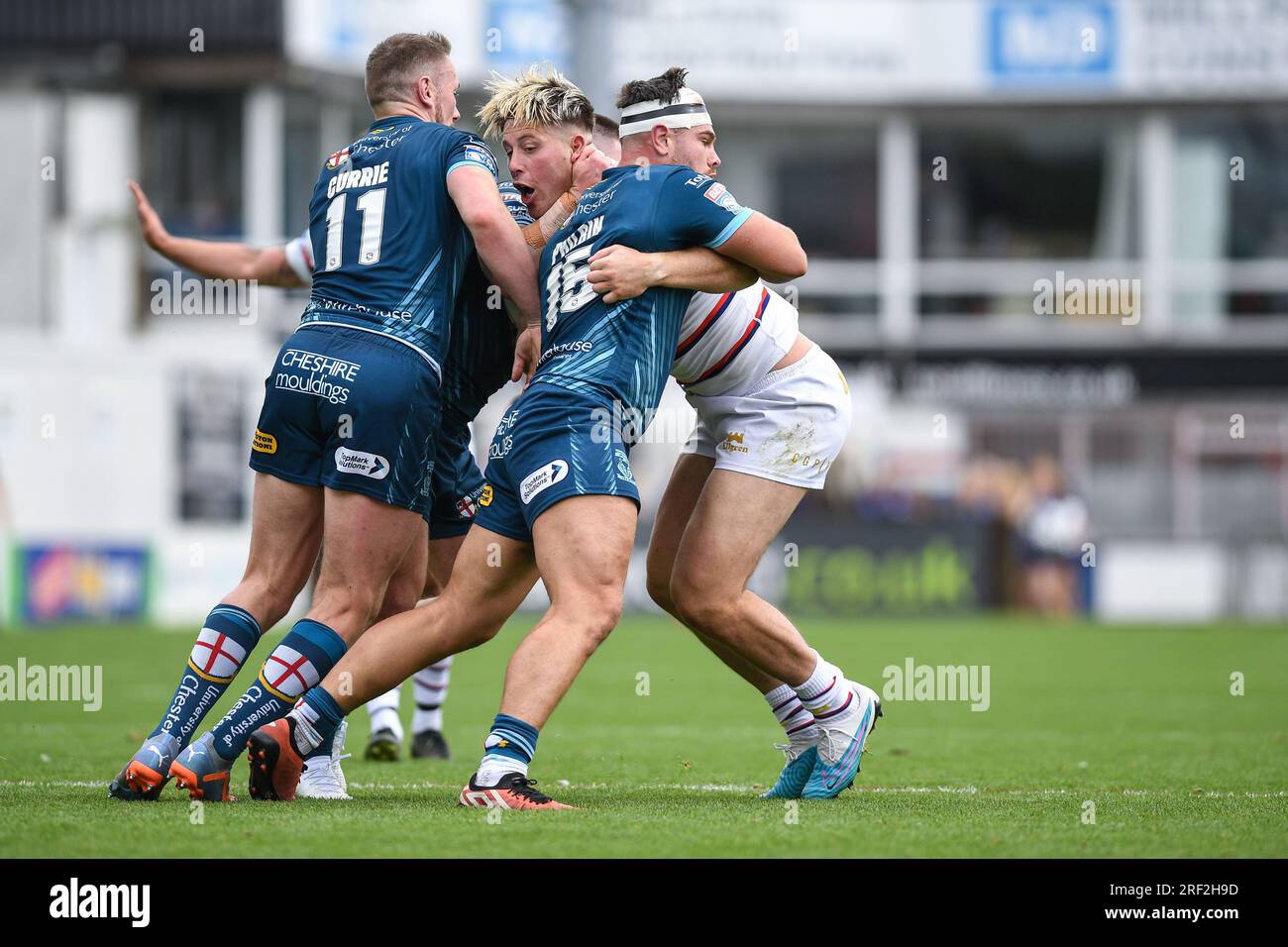Wakefield, England - 30th July 2023 Wakefield Trinity's Tom Lineham takes on former team-mates Ben Currie of and Joe Philbin of Warrington Wolves. Rugby League  Betfred Super League , Wakefield Trinity vs Warrington Wolves at Be Well Support Stadium, Wakefield, UK Stock Photo