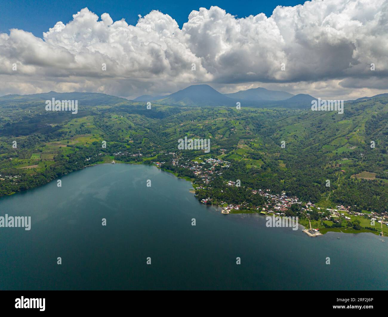 Lanao del Sur: Lake Lanao and mountain with rainforest and town. Mindanao, Philippines. Stock Photo