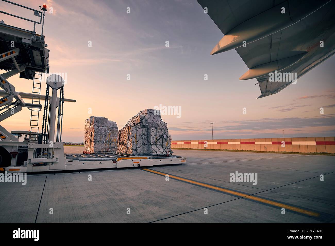 Preparation freight airplane before flight. Loading of cargo containers