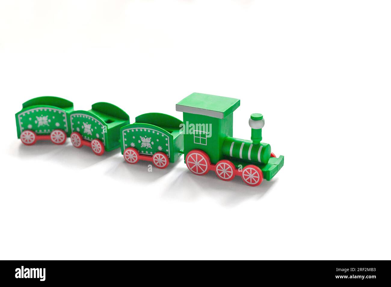 Green Christmas train on a white background. side view. toy Stock Photo
