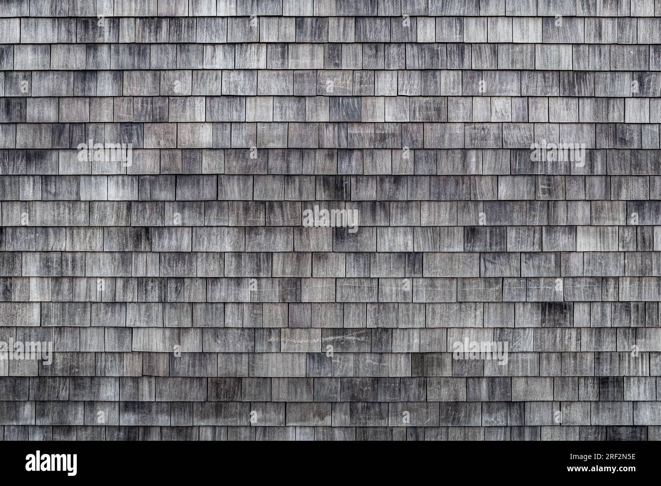 Weathered wooden shingles background. Cedar shake siding pattern for