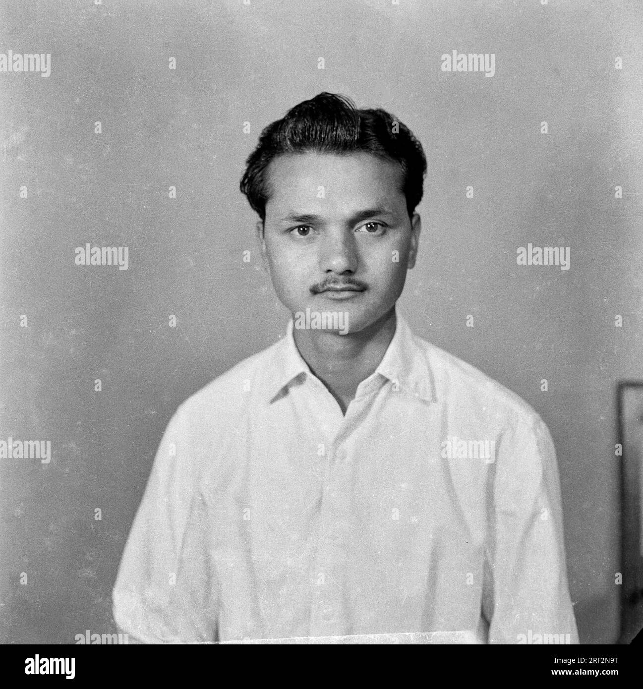 old vintage black and white 1900s picture of Indian Indian man studio portrait wearing shirt India 1940s Stock Photo