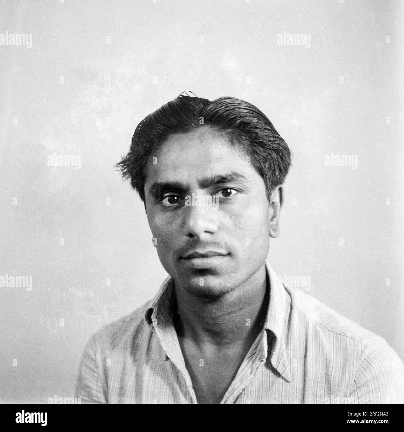 old vintage 1900s black and white picture studio portrait Indian man wearing shirt India Stock Photo