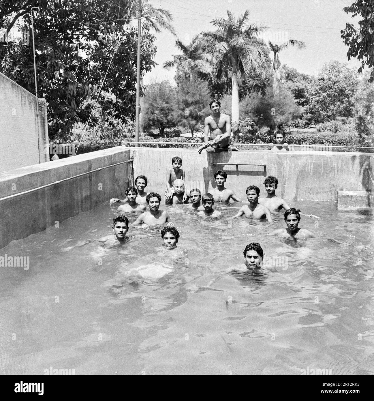 old vintage 1900s black and white picture of Indian village community swimming pool India 1940s Stock Photo
