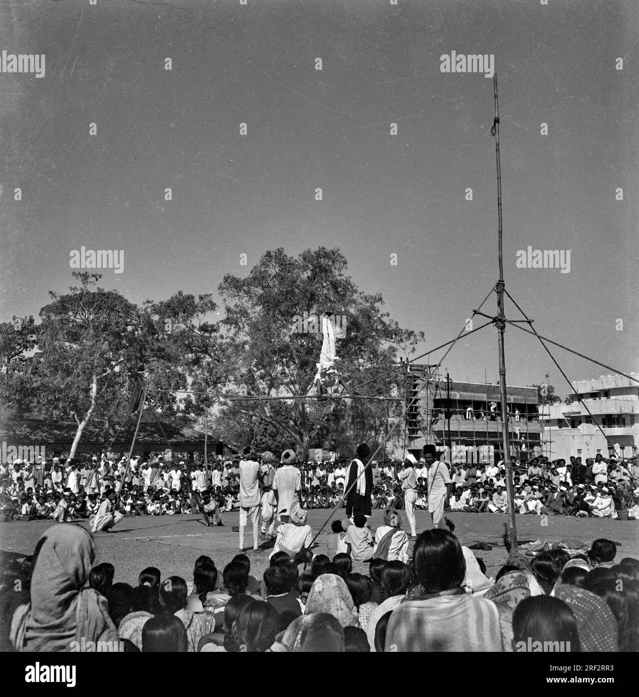 old vintage 1900s black and white picture of Indian rural village acrobat show India 1940s Stock Photo