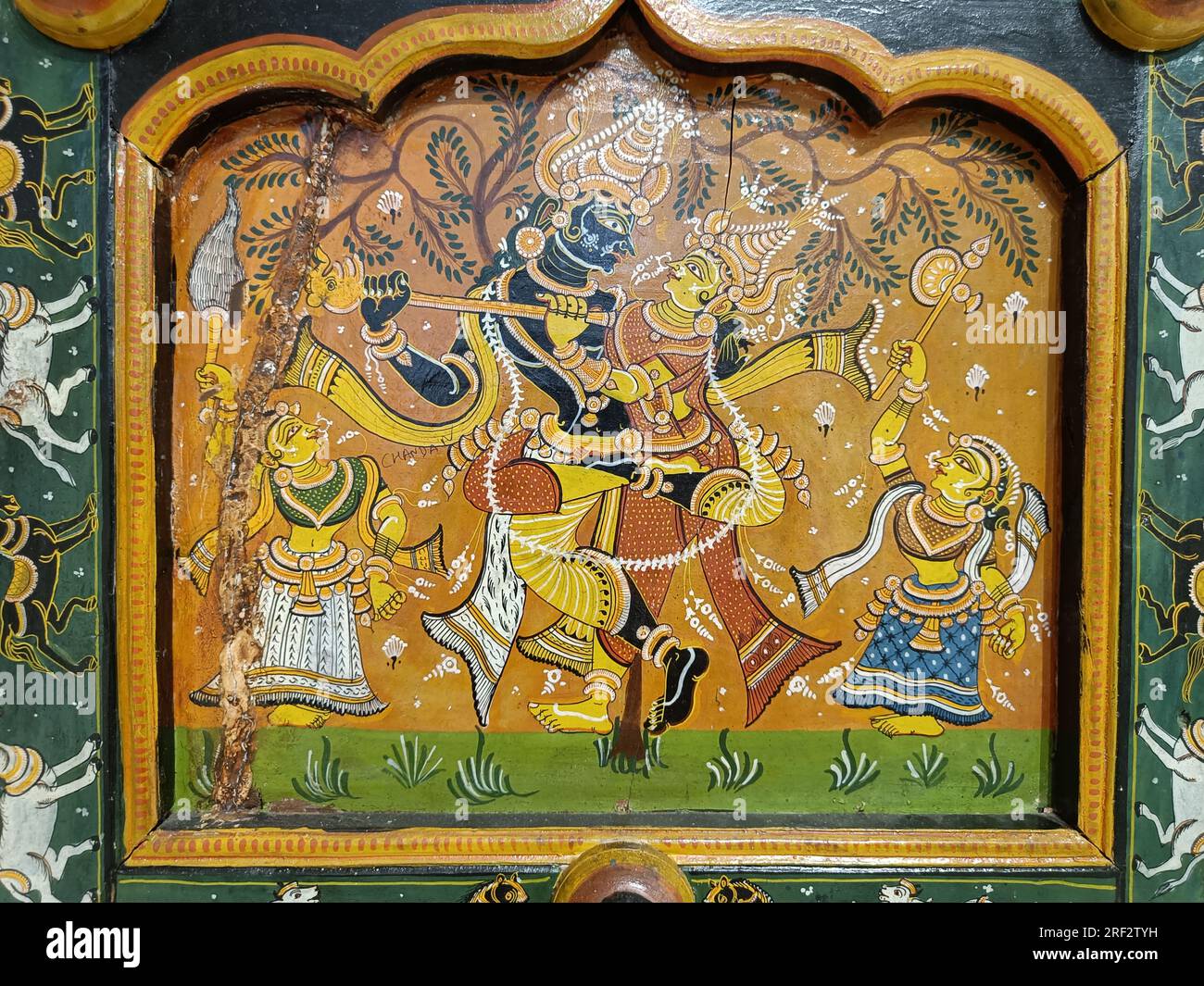 Radha Krishna engaged in public display of affection. Get a room you two. Popular stories of Krishna's life painted on a door. Bhittichitra form. Stock Photo