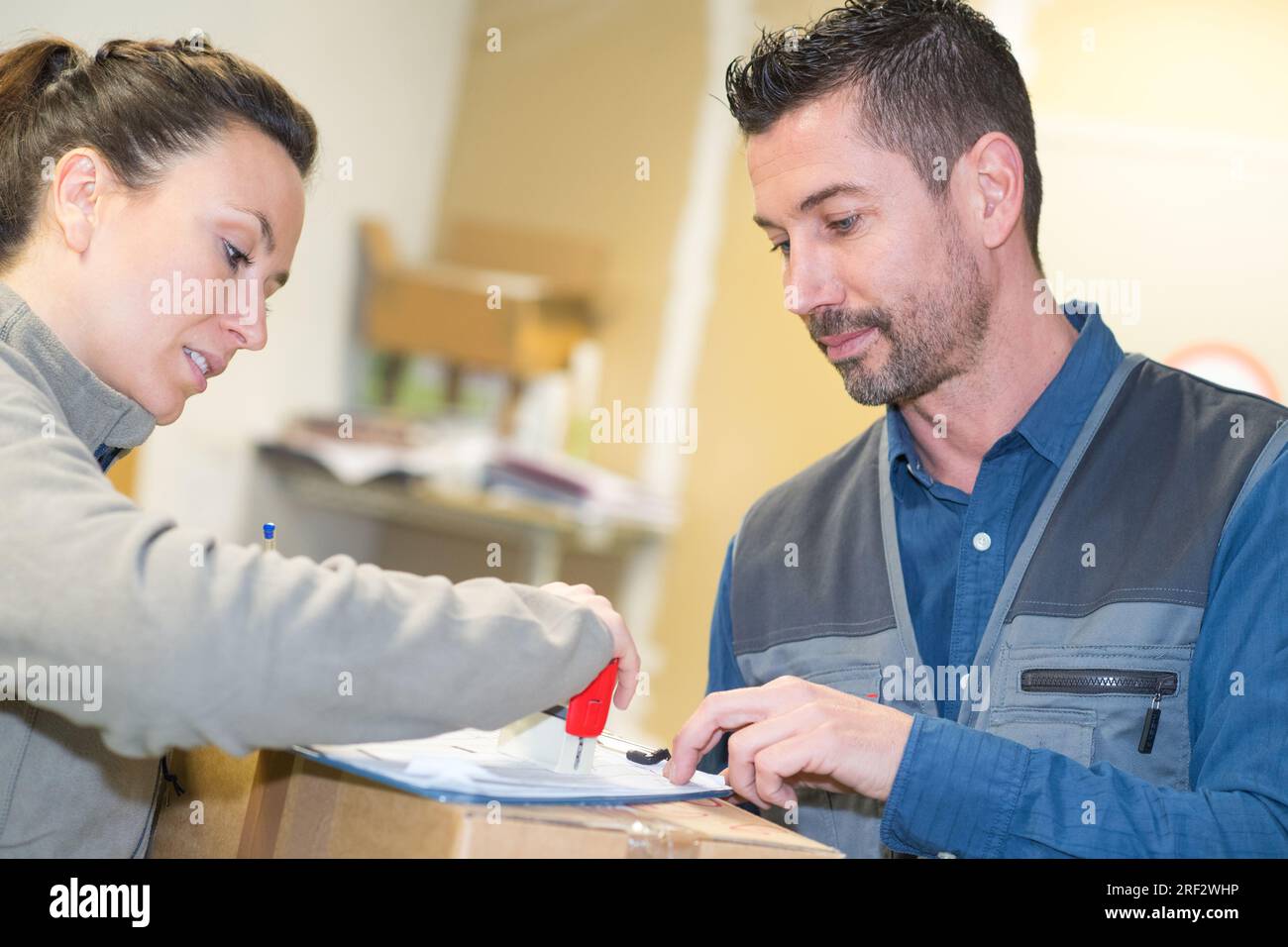 workers signing boxes in warehouse Stock Photo - Alamy