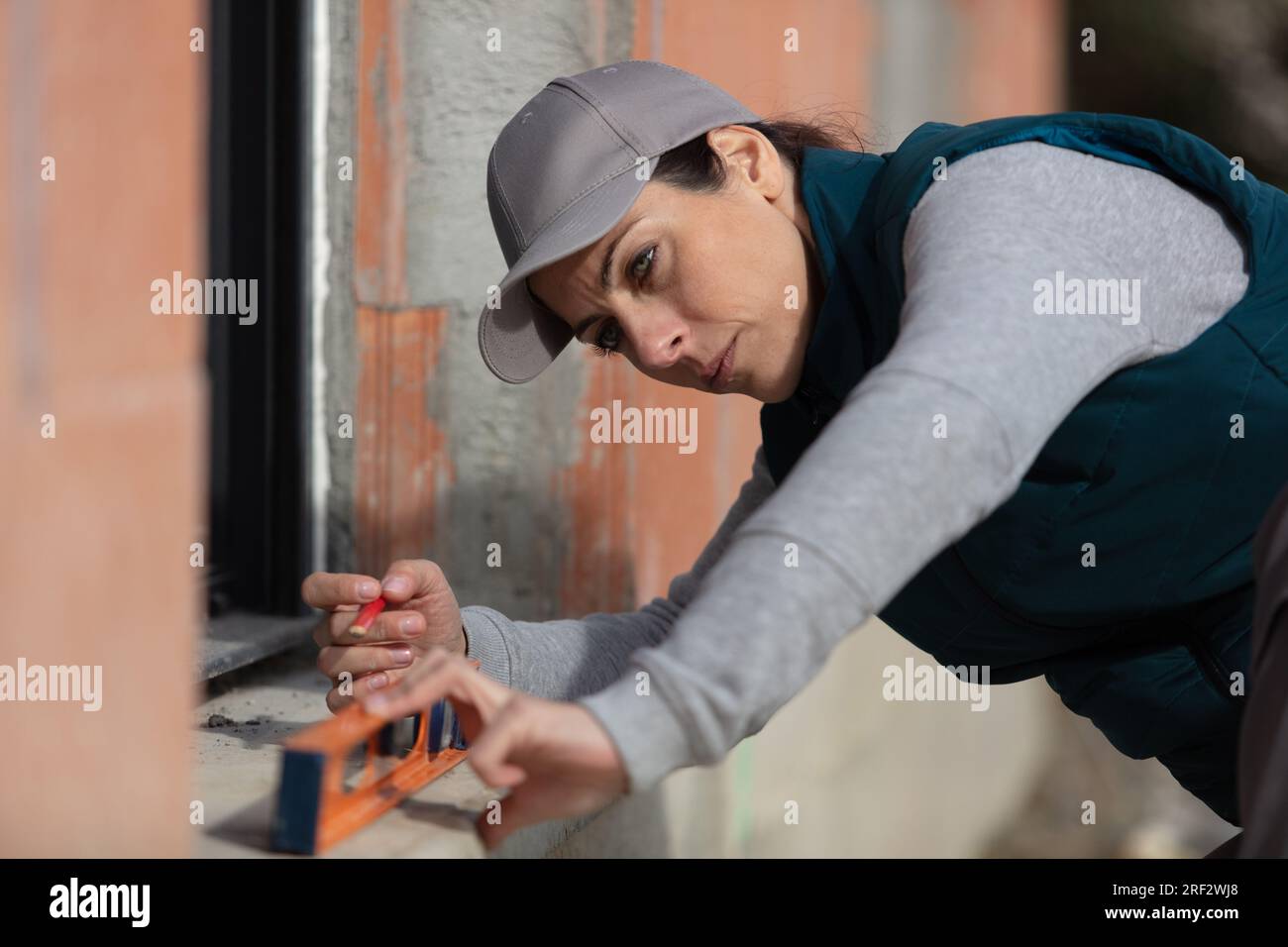 a female builder fixing the window Stock Photo