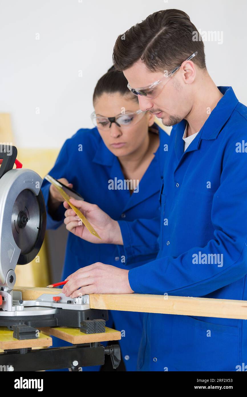 student in carpentry class using circular saw Stock Photo