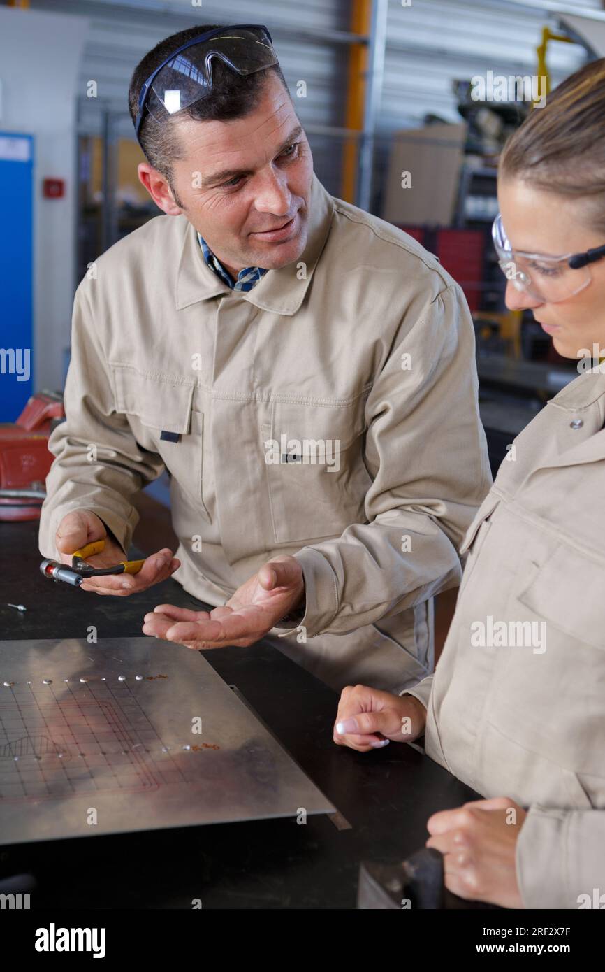two workers soldering metal plates Stock Photo Alamy