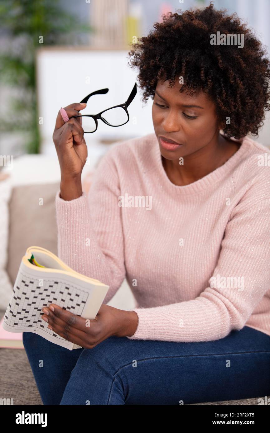 smiling pretty young woman doing crosswords Stock Photo Alamy