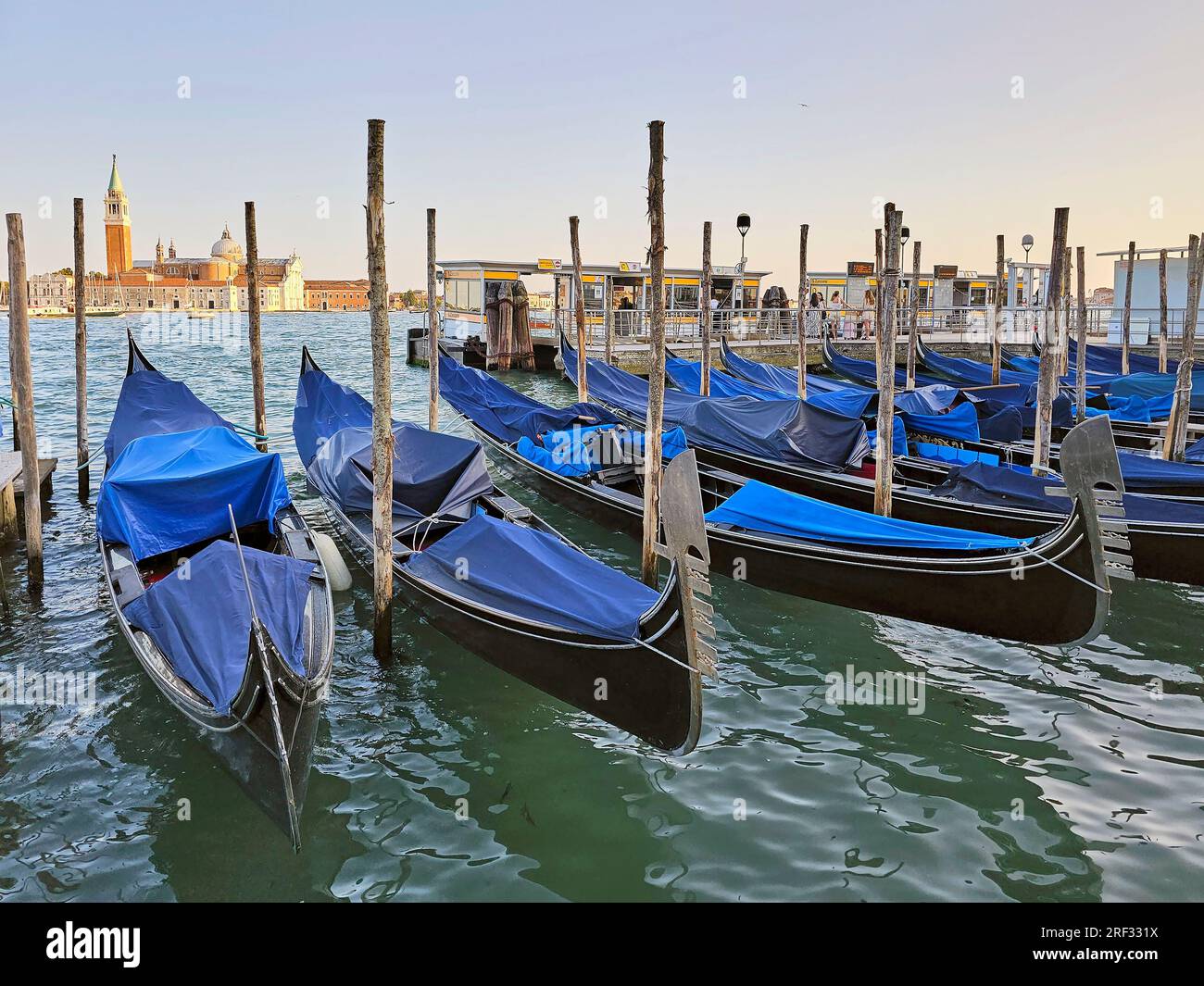 Gondolas on the quay in Venetian lagoon Stock Photo - Alamy