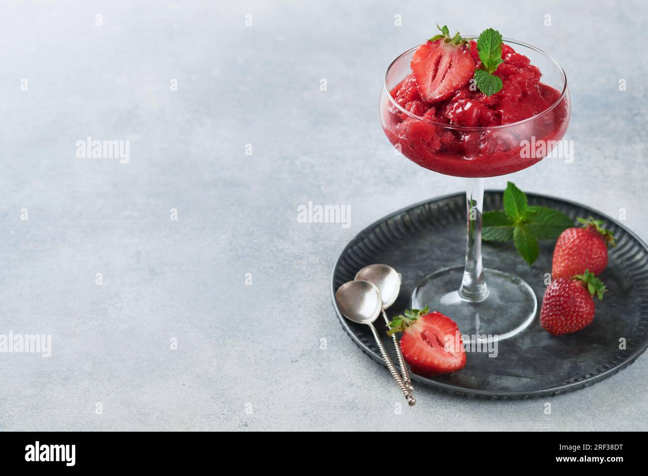 https://c8.alamy.com/comp/2RF38DT/strawberry-granita-or-fresh-berry-sorbet-in-glass-on-old-grey-table-background-texture-of-ice-cream-or-sorbet-ice-cream-with-strawberry-and-mint-s-2RF38DT.jpg