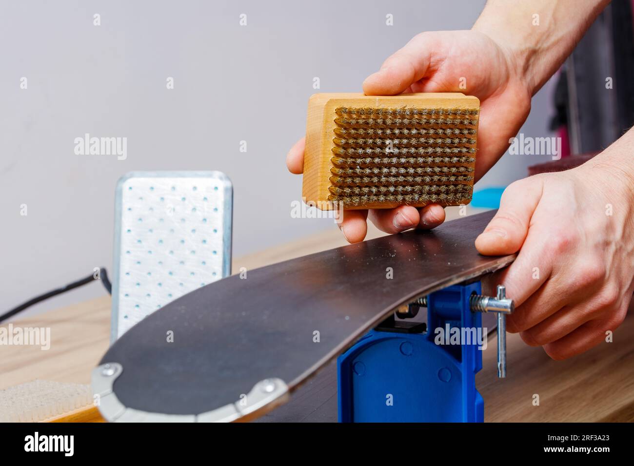 Precise cleaning of alpine ski base by man in Stock Photo Alamy