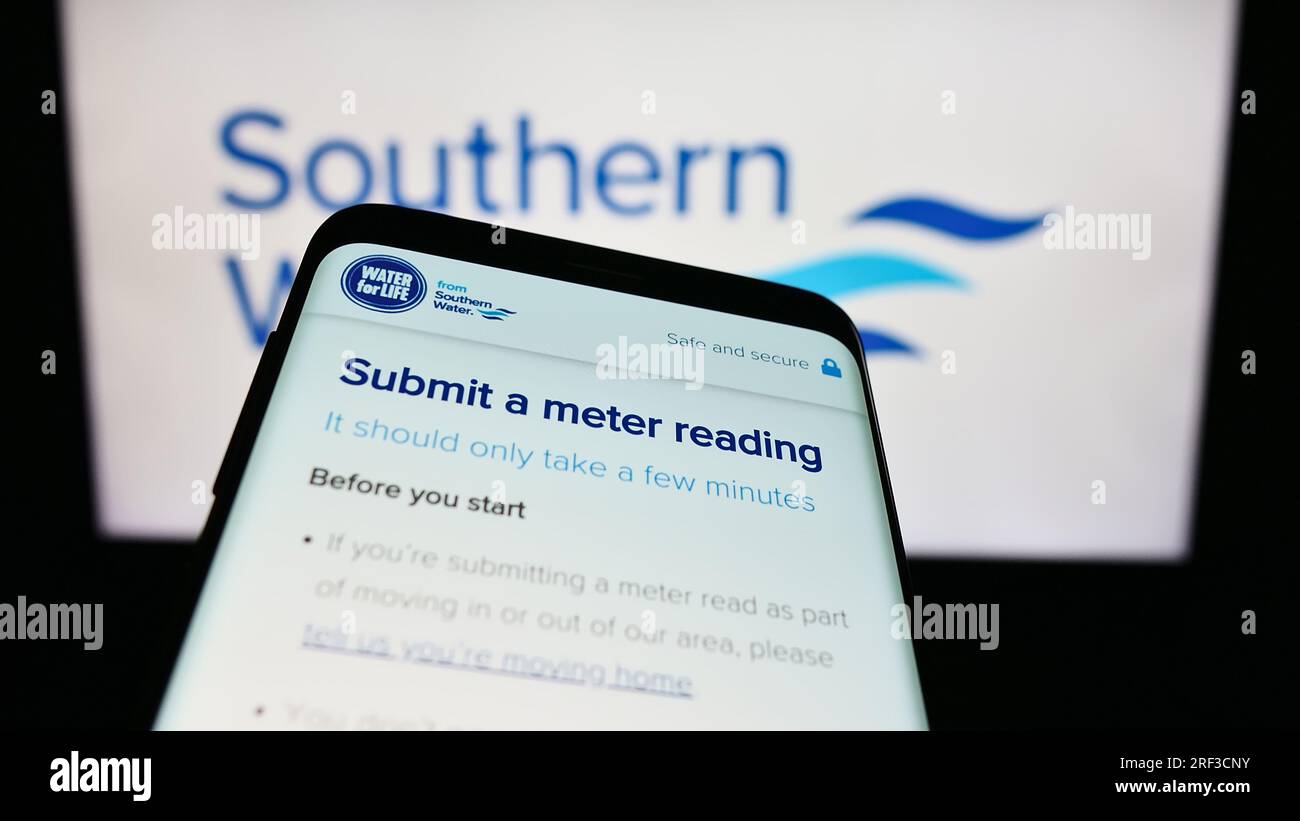 Mobile phone with webpage of British company Southern Water Services Limited on screen in front of logo. Focus on top-left of phone display. Stock Photo
