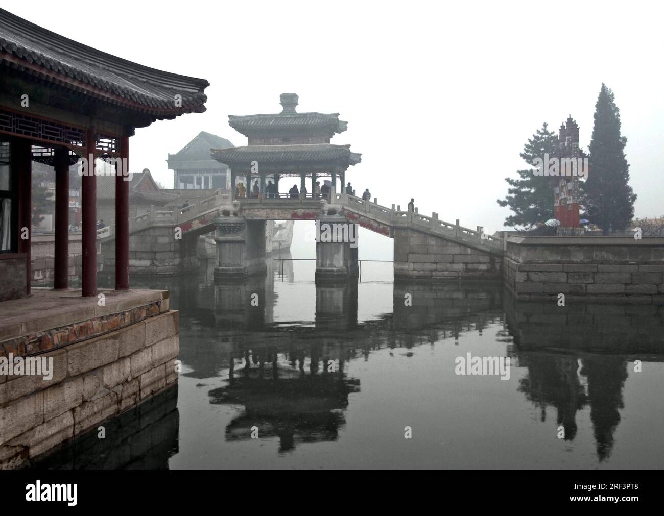 rainy scenery with traditional buildings, water and bridge around Beiling in China Stock Photo