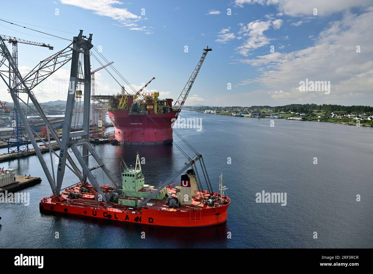 Norwegian crane ship Uglen and floating storage/production vessel Penguins FPSO in the Karmsund at Haugesund in Rogaland county, Western Norway. Stock Photo