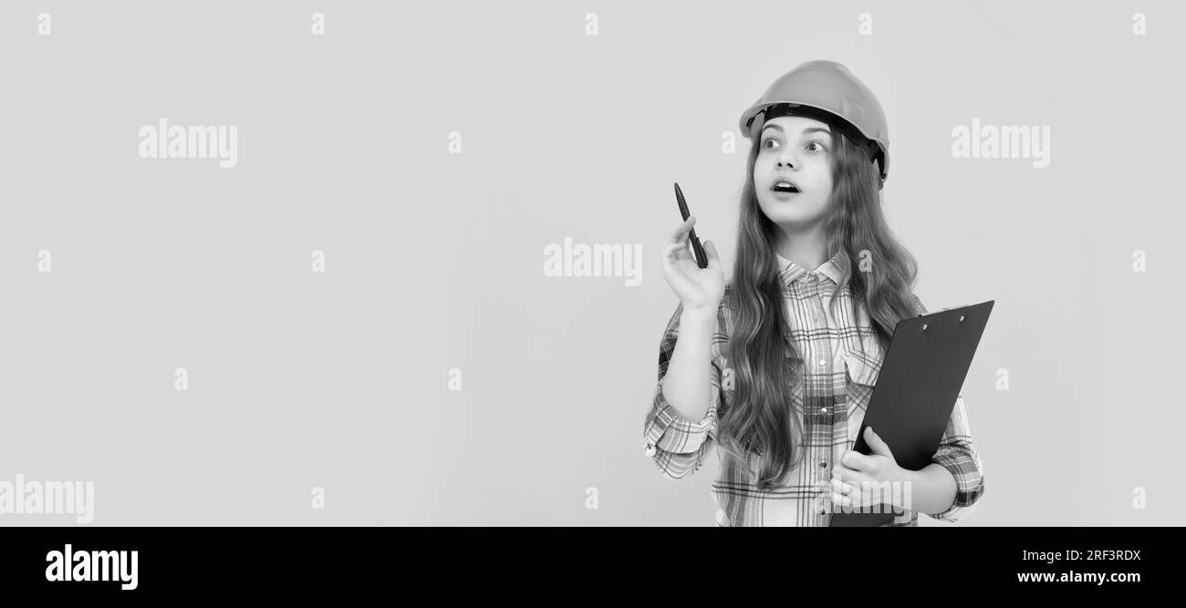 concentrated child worker wear hardhat hold clipboard. childhood ...