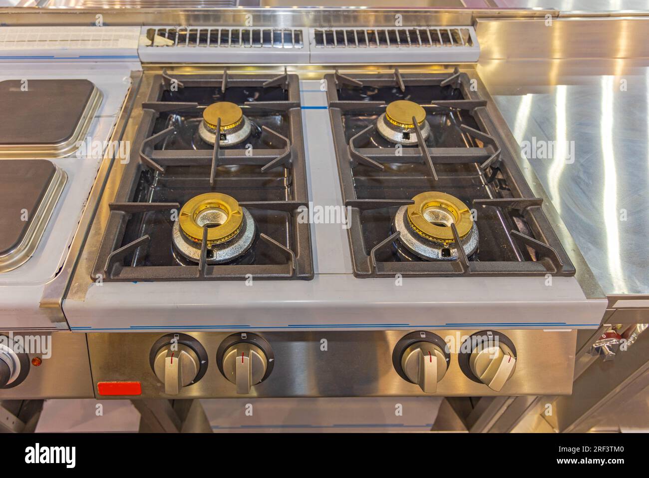 Large Gas Burner Hob Stove in Commercial Restaurant Kitchen Stock Photo