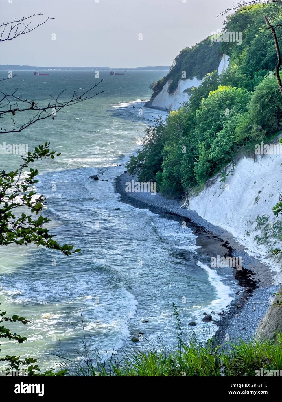 Waves in sea near coastline on empty pebble beach Stock Photo - Alamy