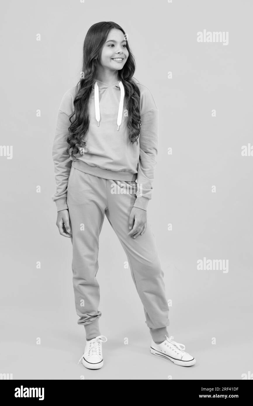 Sports studio kids portrait. Cute teenager girl in a purple casual