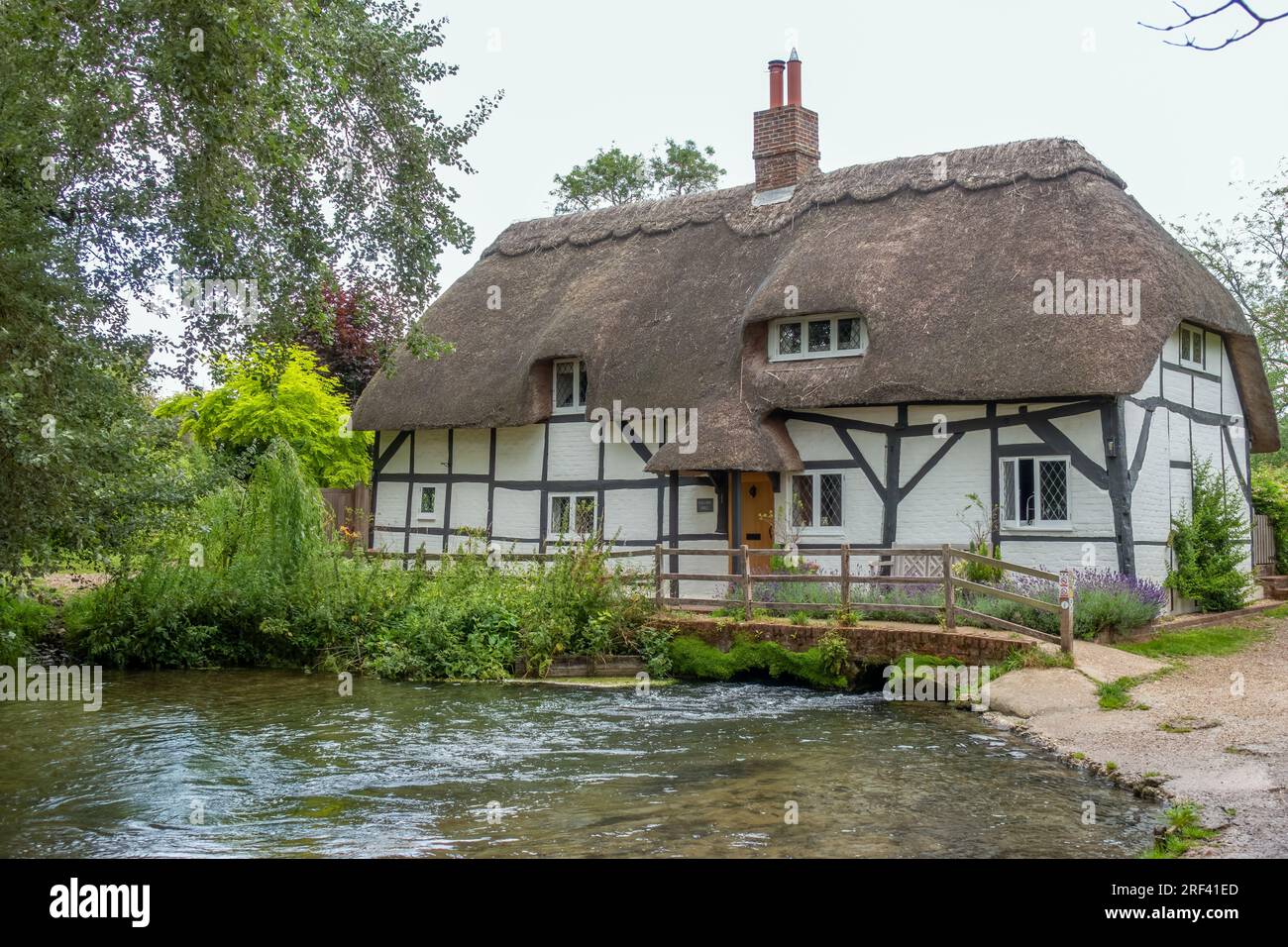 The Fulling Mill across the River Alre in Alresford Hampshire England Stock Photo